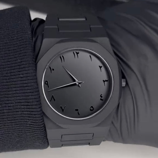 Black wristwatch on a plain background