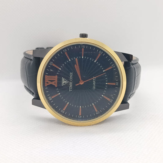 Watch with black strap and gold bezel on a white background