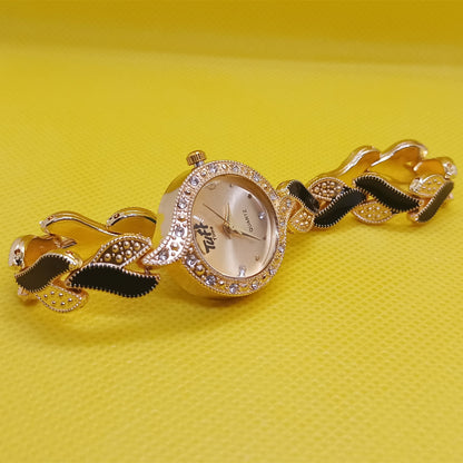 Gold wristwatch with decorative band on a yellow background