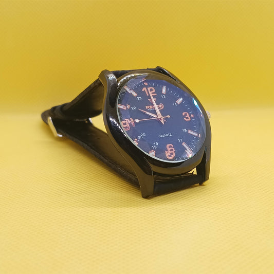 Black wristwatch with blue face on a yellow background