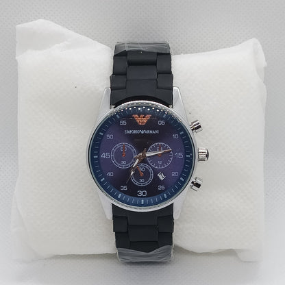 Wristwatch with black strap and blue dial on a white cushion