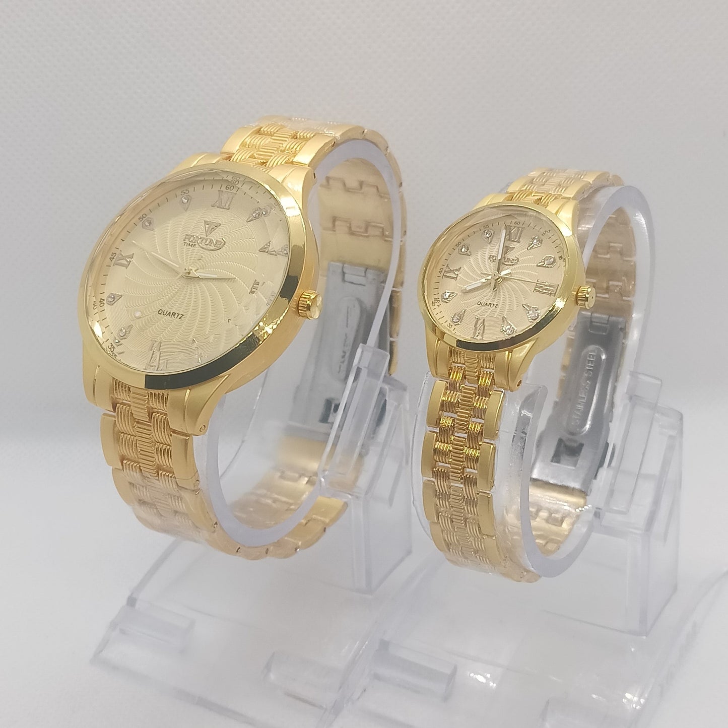 Two gold wristwatches on a white background