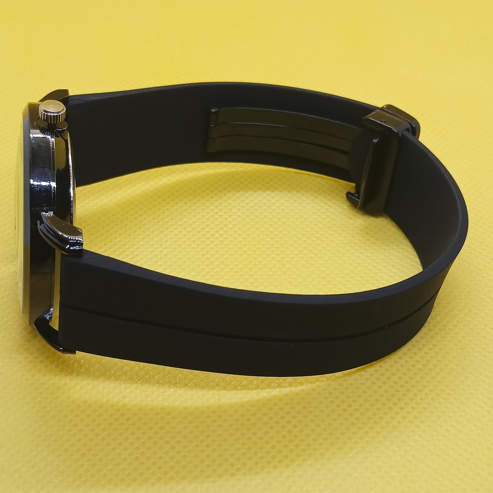 Black belt with metal buckle on a yellow background