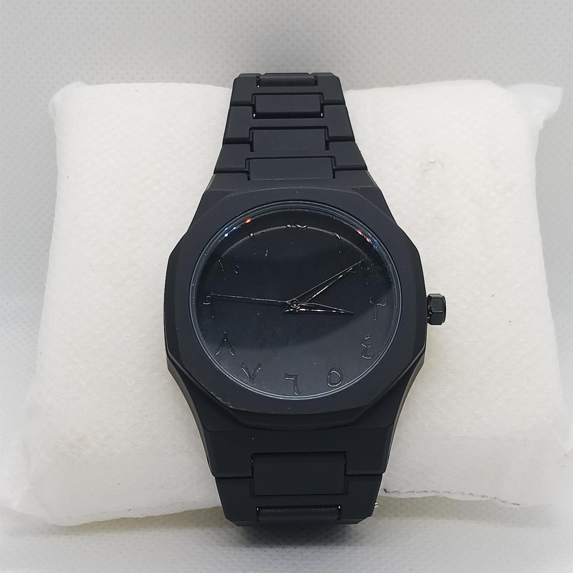 Black watch on a white cushion