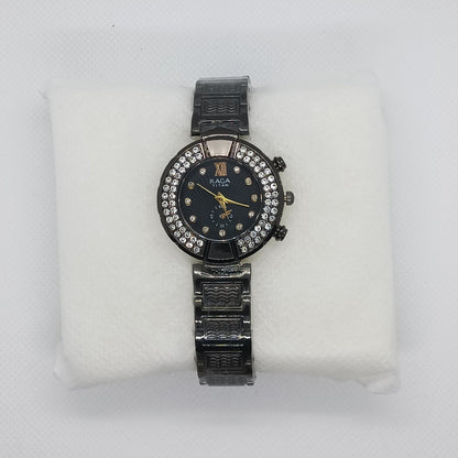 Black wristwatch with diamond accents on a white cushion against a light gray background