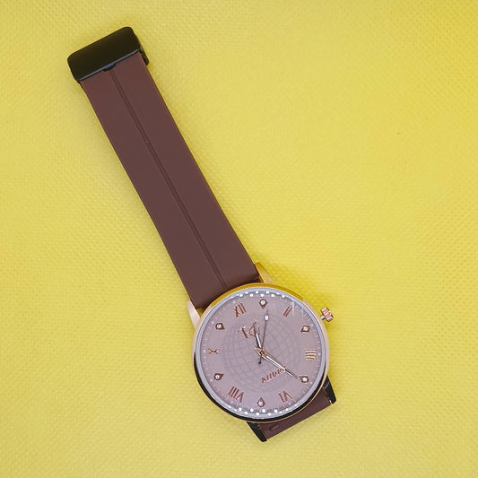 Wristwatch with a brown strap on a yellow background