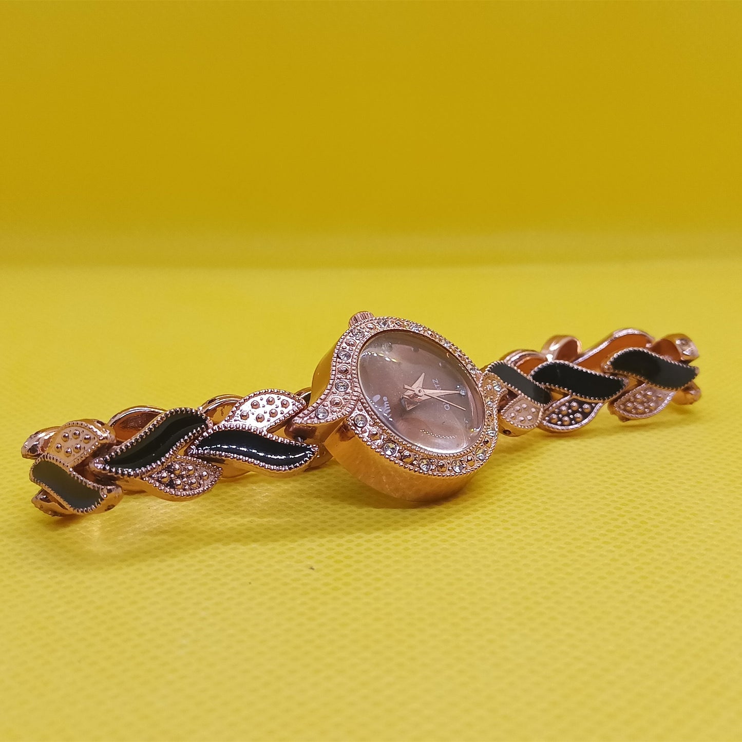 Decorative brooch with intricate design on a yellow background