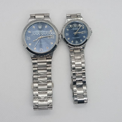 Two silver wristwatches with blue faces on a light gray background
