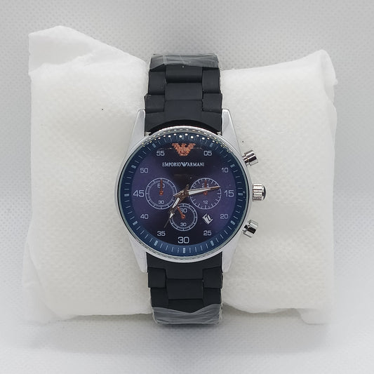 Wristwatch with black strap and blue face on a white cushion