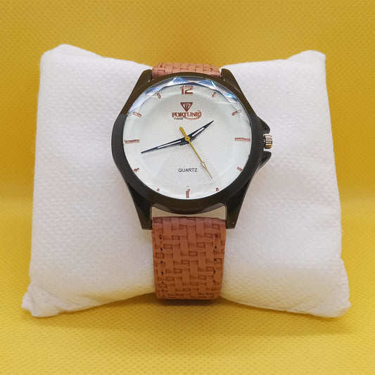Watch with a brown strap on a white cushion against a yellow background