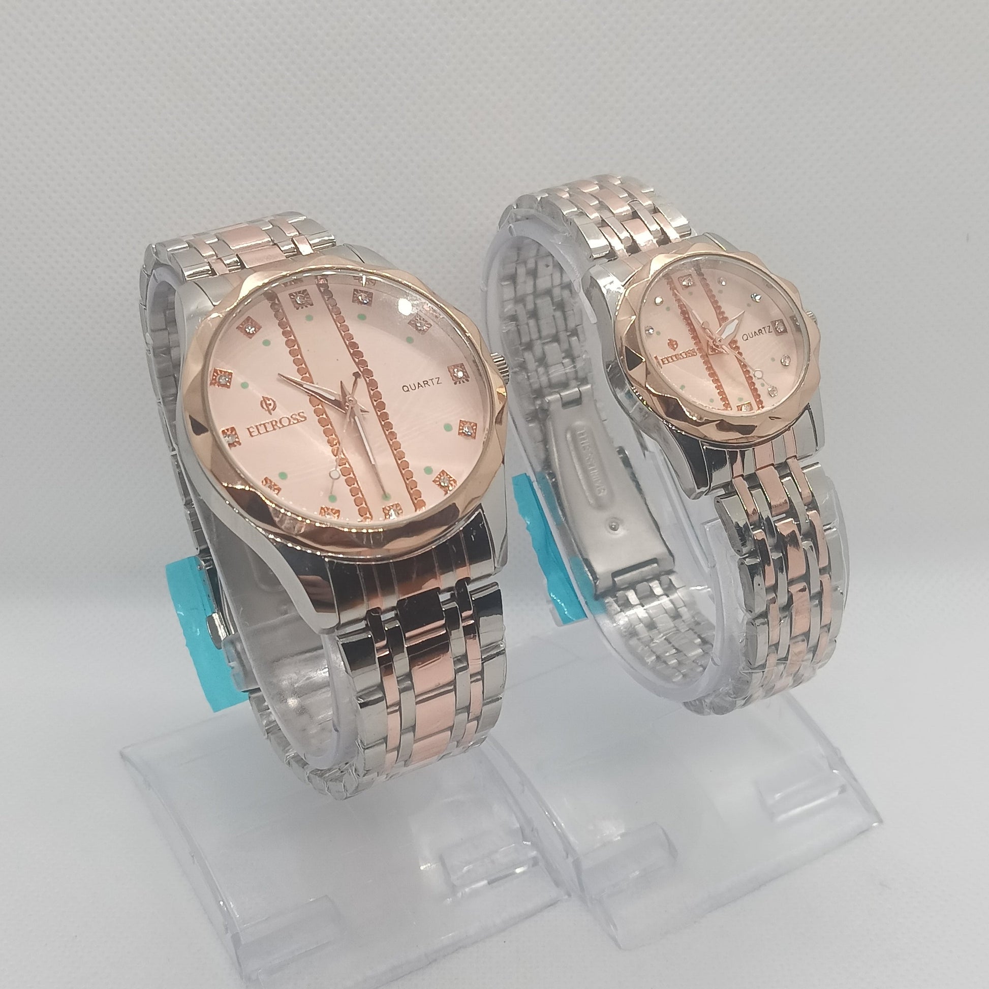 Two silver and rose gold watches on a white background