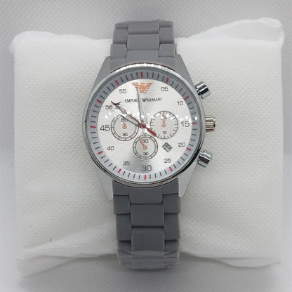 Gray wristwatch with a detailed face on a white cushion