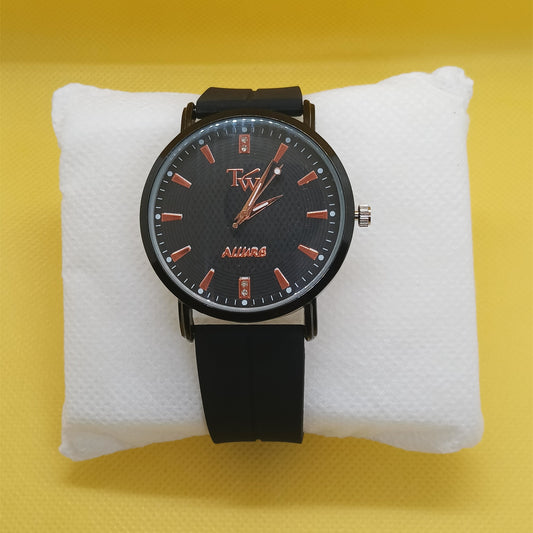 Black wristwatch with red accents on a white cushion against a yellow background